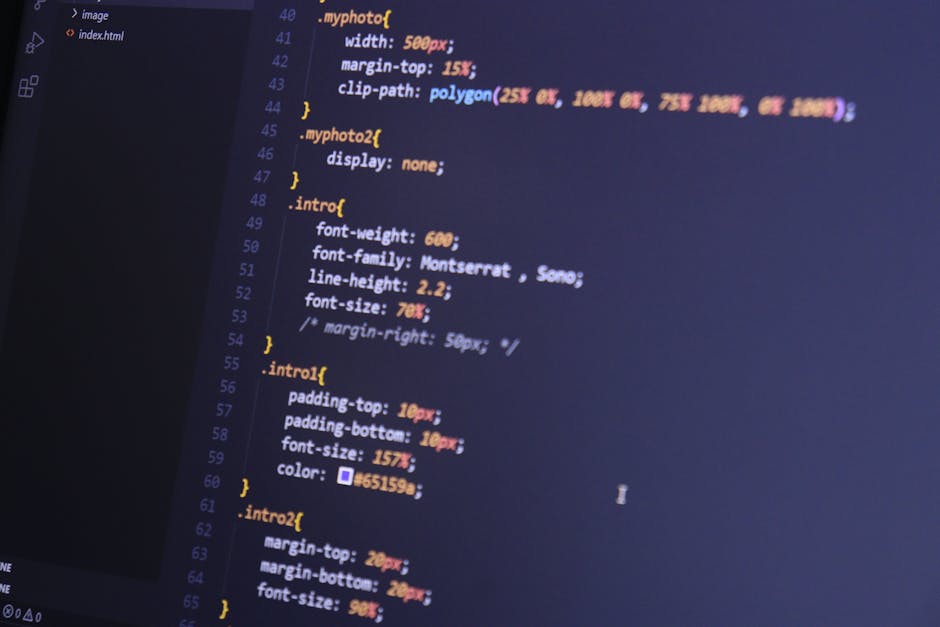 A close-up view of a computer screen displaying HTML code, including tags such as <html>, <head>, <title>, and <body>. The code is color-coded with different syntax highlighting, showing elements like